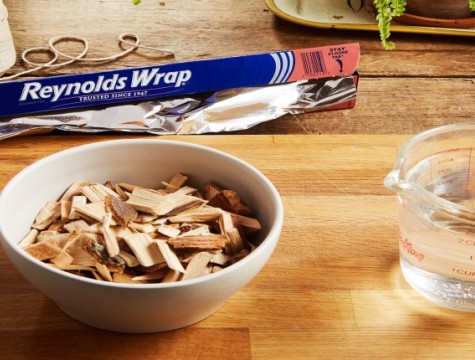 Bowl of wood chips next to a cup of water